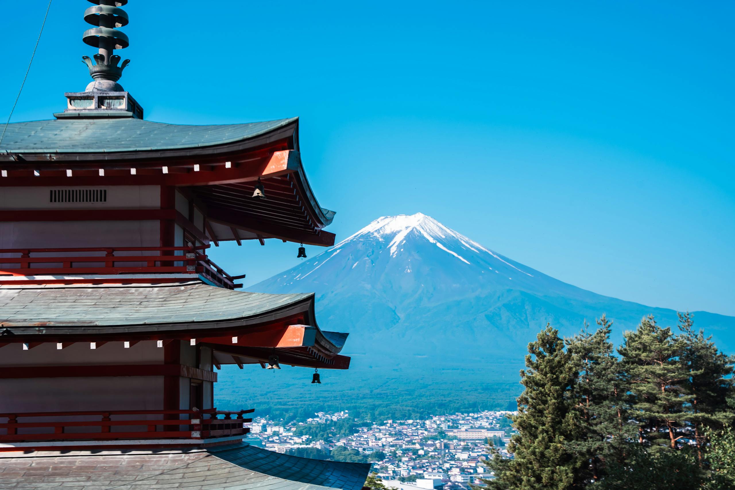 Scenic view of Chureito Pagoda with Mount Fuji in the background under a clear blue sky.